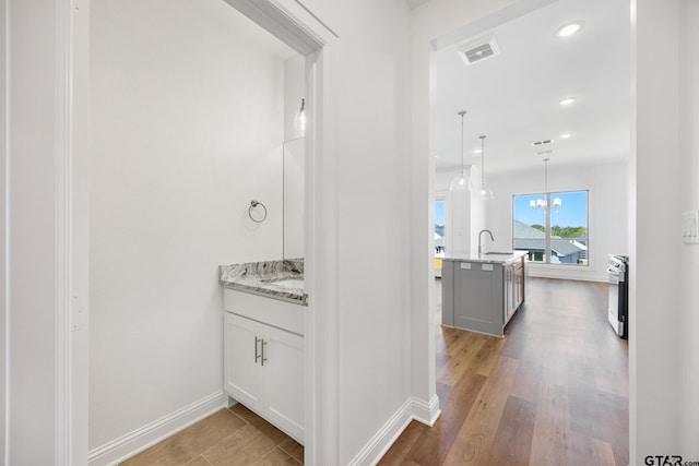 482 Mary Cir, Bullard, TX 75757 - hall featuring a sink, recessed lighting, baseboards, and wood finished floors