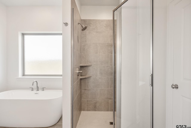 bathroom featuring separate shower and tub