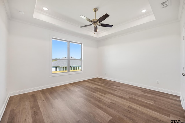 482 Mary Cir, Bullard, TX 75757 - unfurnished room featuring a raised ceiling, crown molding, wood finished floors, ceiling fan, and baseboards