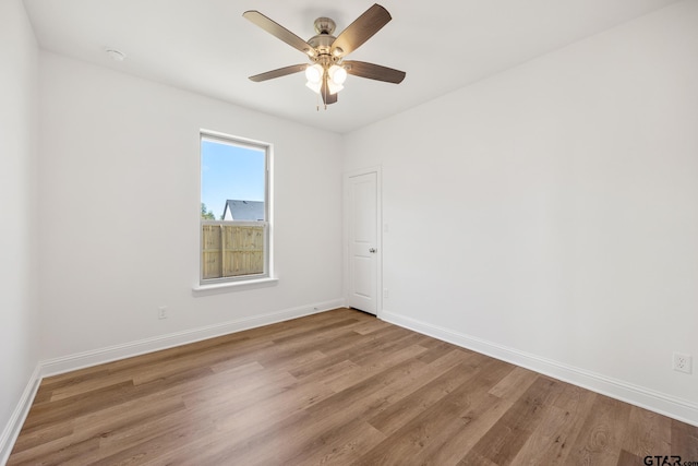 empty room featuring ceiling fan and light hardwood / wood-style floors