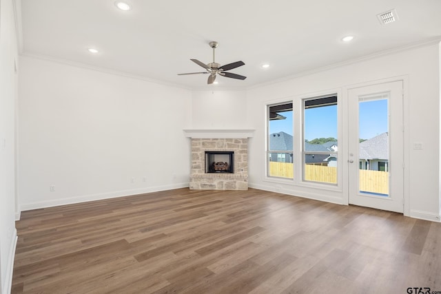 482 Mary Cir, Bullard, TX 75757 - unfurnished living room featuring ornamental molding, a ceiling fan, wood finished floors, baseboards, and a stone fireplace