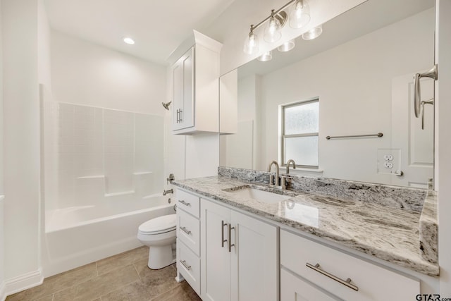 full bathroom with washtub / shower combination, vanity, and toilet