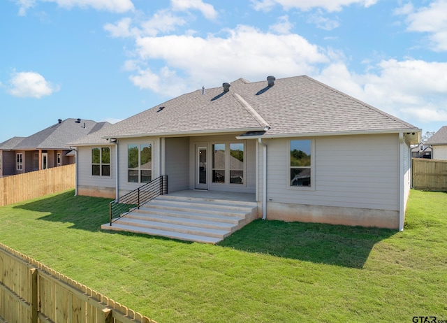 rear view of house with a patio area and a yard