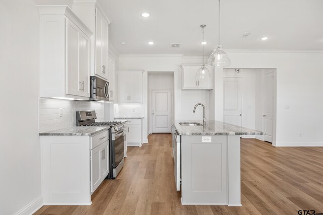 kitchen with sink, white cabinets, stainless steel appliances, and light wood-type flooring