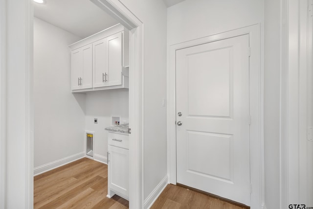 laundry area featuring electric dryer hookup, hookup for a washing machine, and light hardwood / wood-style floors