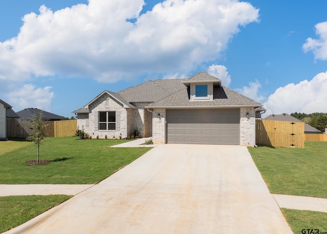 view of front of property with a garage and a front lawn