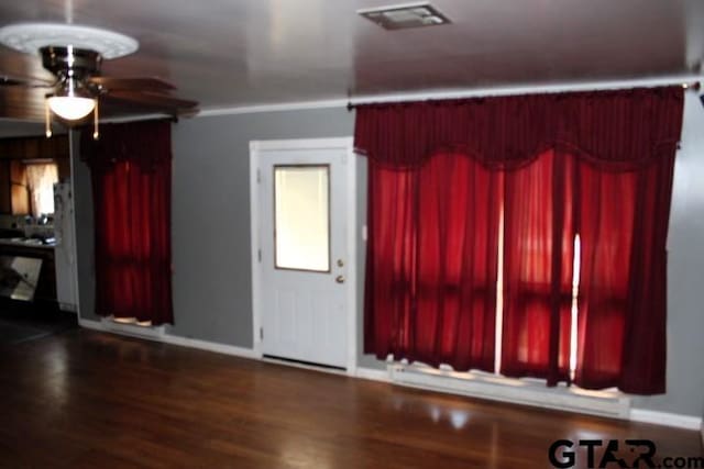 interior space with ceiling fan and dark hardwood / wood-style flooring