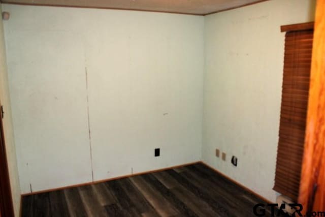 307 Lowry St, Arp, TX 75750 - unfurnished room featuring dark wood-type flooring