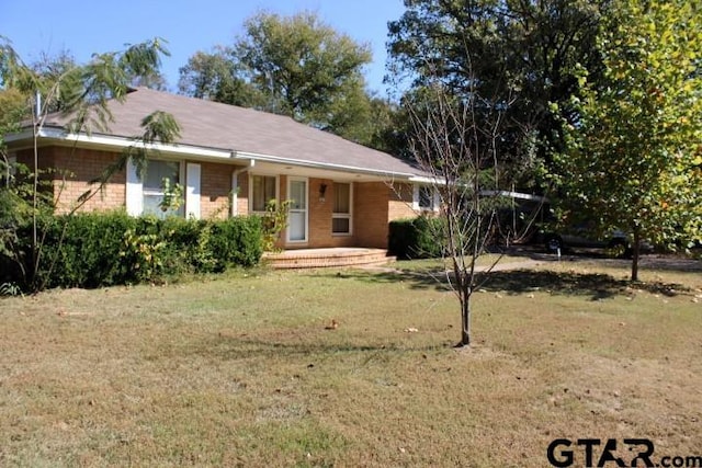 ranch-style house with a front yard and covered porch