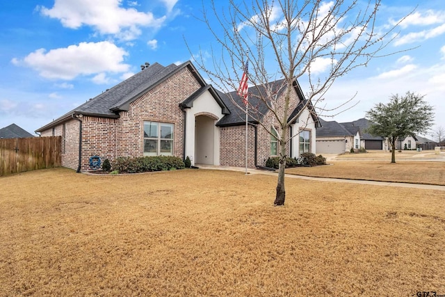 view of front of property featuring a garage and a front lawn