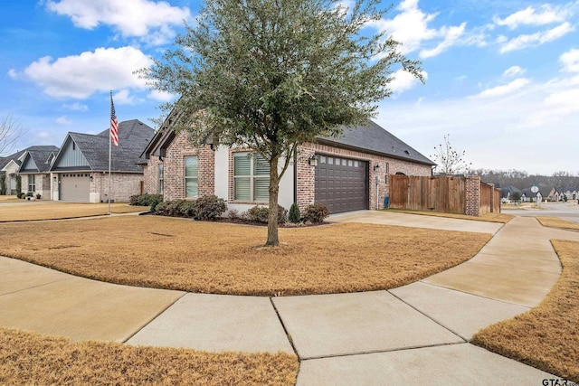 view of front of property with a garage and a front lawn