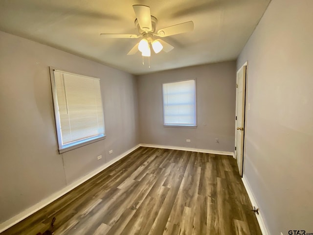 spare room with ceiling fan and dark hardwood / wood-style flooring