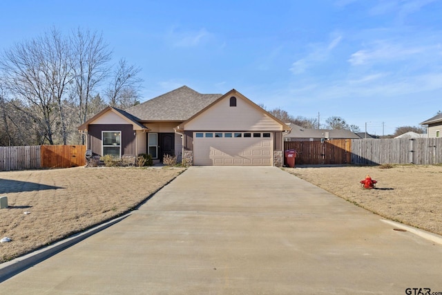 view of front facade with roof with shingles, concrete driveway, fence, a garage, and stone siding