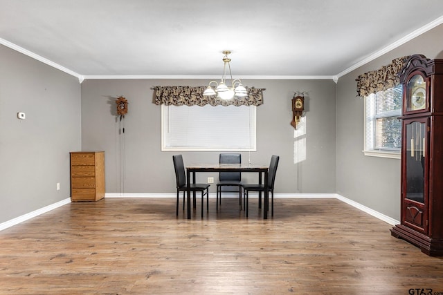 dining room featuring baseboards, a chandelier, wood finished floors, and ornamental molding