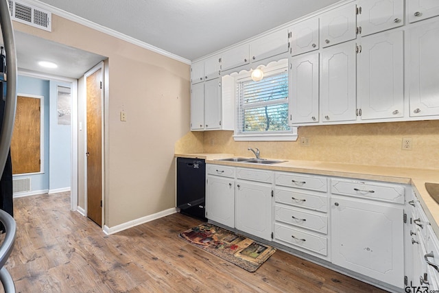 kitchen with light countertops, dishwasher, visible vents, and white cabinetry