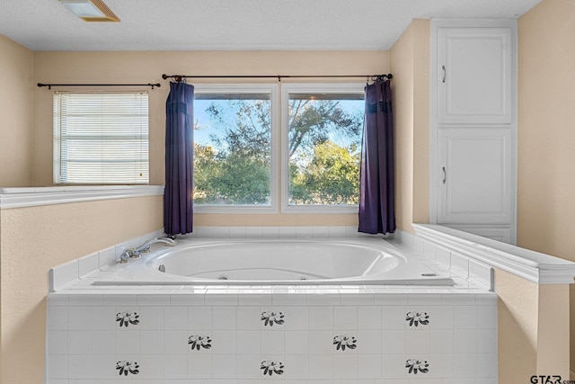 bathroom featuring a textured ceiling and a whirlpool tub