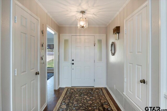 17599 Autumn Trl, Whitehouse, TX 75791 - foyer with ornamental molding, baseboards, dark wood-style flooring, and an inviting chandelier