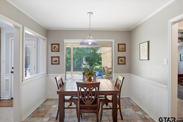 17599 Autumn Trl, Whitehouse, TX 75791 - dining space with stone tile floors, a wainscoted wall, and ornamental molding