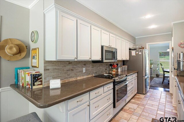 17599 Autumn Trl, Whitehouse, TX 75791 - kitchen featuring crown molding, tasteful backsplash, stainless steel appliances, and white cabinetry