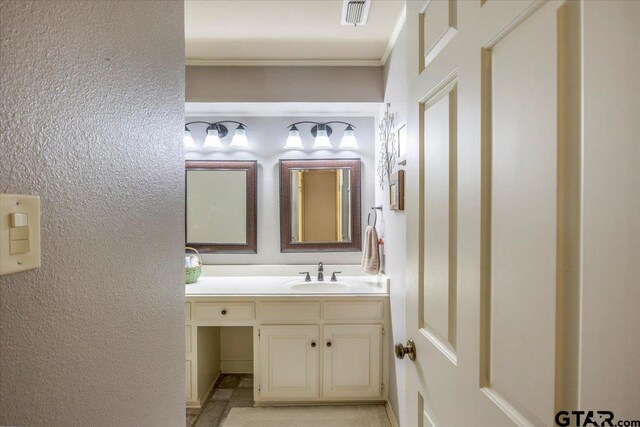 17599 Autumn Trl, Whitehouse, TX 75791 - bathroom featuring a textured wall, visible vents, vanity, and ornamental molding