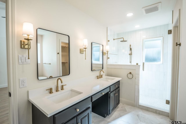 bathroom with vanity and a shower with door