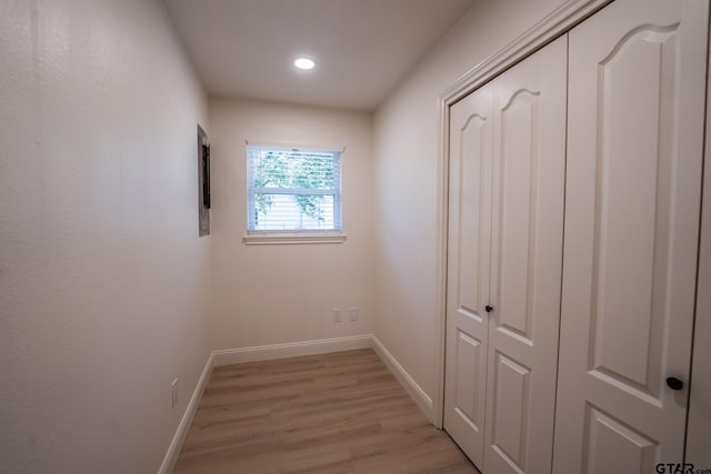 corridor with light wood-type flooring