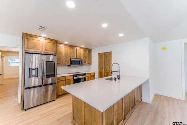 kitchen featuring kitchen peninsula, light hardwood / wood-style flooring, stainless steel appliances, and sink