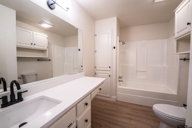 full bathroom with washtub / shower combination, wood-type flooring, vanity, and toilet