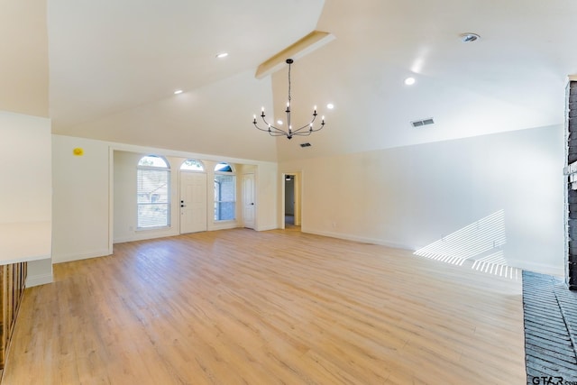 unfurnished living room featuring a chandelier, beamed ceiling, high vaulted ceiling, and light hardwood / wood-style floors