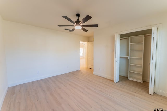 unfurnished bedroom featuring ceiling fan, light wood-type flooring, and a closet