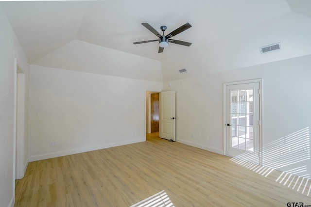 spare room featuring ceiling fan, light wood-type flooring, and vaulted ceiling