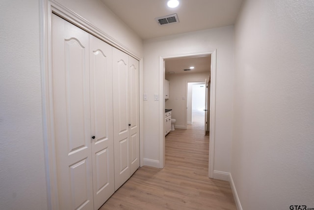 hall with light hardwood / wood-style floors