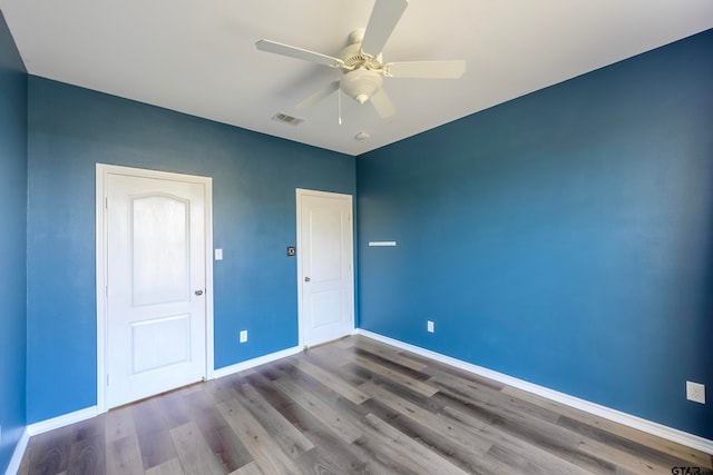 unfurnished bedroom featuring ceiling fan and hardwood / wood-style flooring