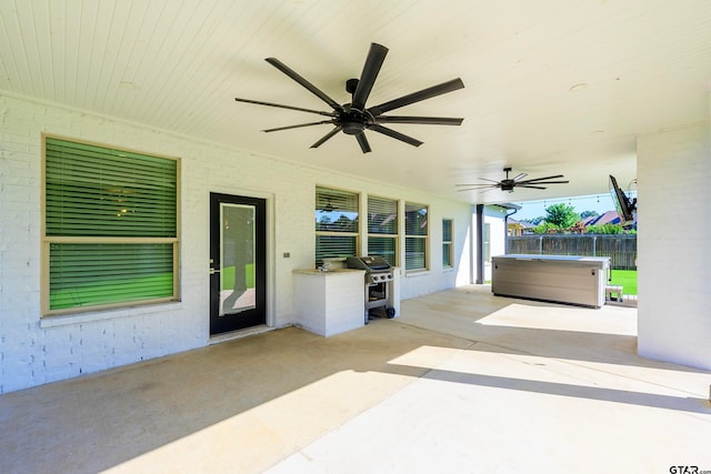 view of patio / terrace featuring a hot tub and ceiling fan