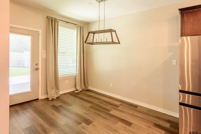 unfurnished dining area featuring hardwood / wood-style flooring