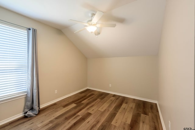 bonus room featuring ceiling fan, lofted ceiling, and dark wood-type flooring