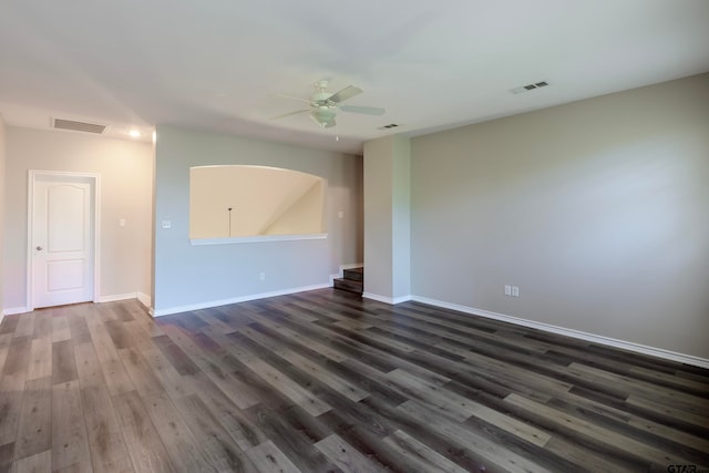 empty room featuring dark hardwood / wood-style flooring and ceiling fan