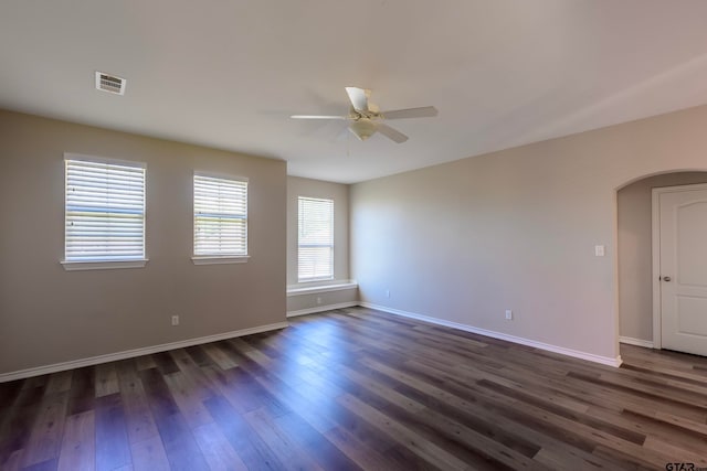 empty room featuring ceiling fan and dark hardwood / wood-style flooring