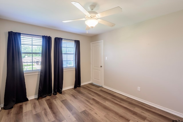 spare room with ceiling fan and hardwood / wood-style floors