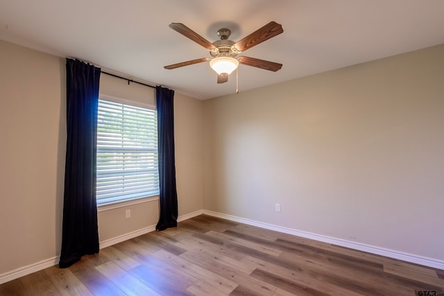 spare room featuring light wood-type flooring and ceiling fan