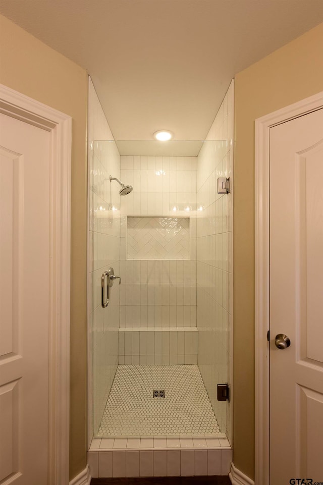 bathroom with a shower with shower door