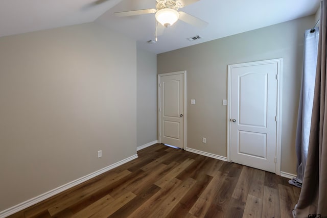 unfurnished bedroom with ceiling fan, dark hardwood / wood-style flooring, and vaulted ceiling