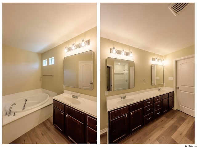 bathroom with a bathing tub, vanity, and hardwood / wood-style flooring