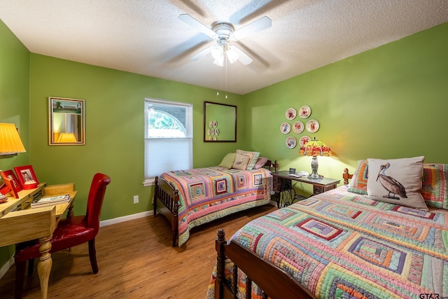 bedroom featuring a textured ceiling, hardwood / wood-style flooring, and ceiling fan