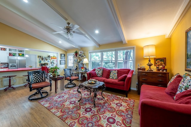 living room featuring vaulted ceiling with beams, ceiling fan, and light wood-type flooring