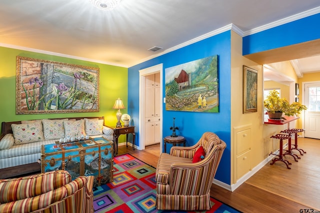 sitting room featuring hardwood / wood-style flooring and crown molding