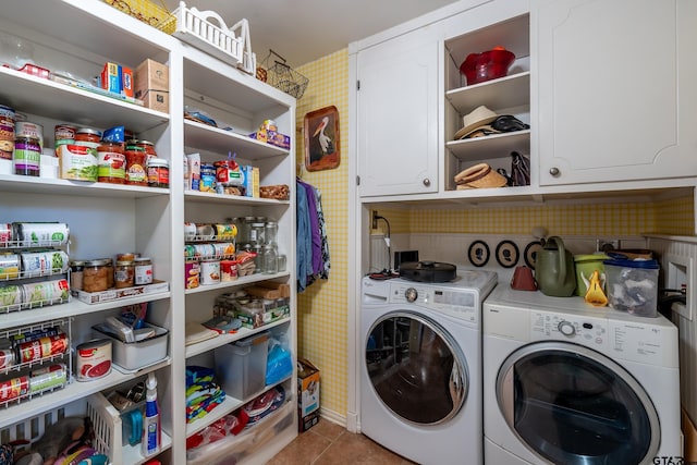 laundry area featuring cabinets, independent washer and dryer, and light tile patterned floors