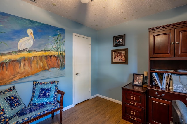 office with a textured ceiling and hardwood / wood-style flooring