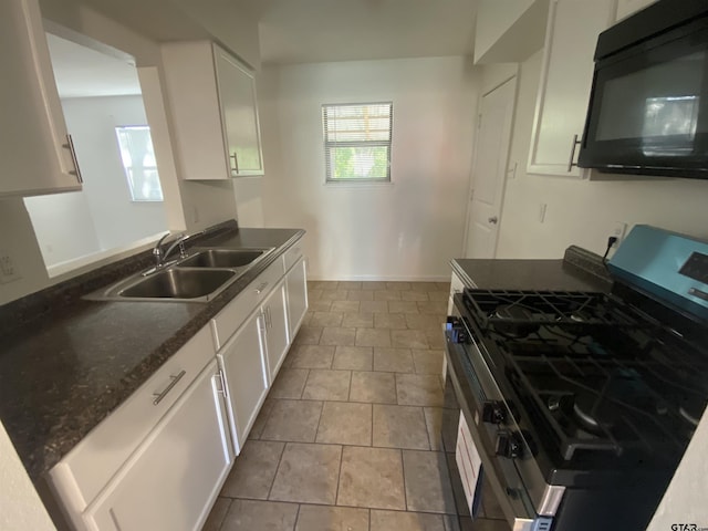 3903 Appletree Ln, Tyler, TX 75701 - kitchen featuring stainless steel gas stove, black microwave, white cabinetry, and tile patterned flooring