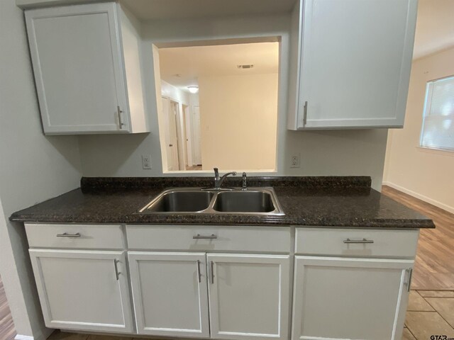 3903 Appletree Ln, Tyler, TX 75701 - kitchen featuring white cabinetry and dark stone counters